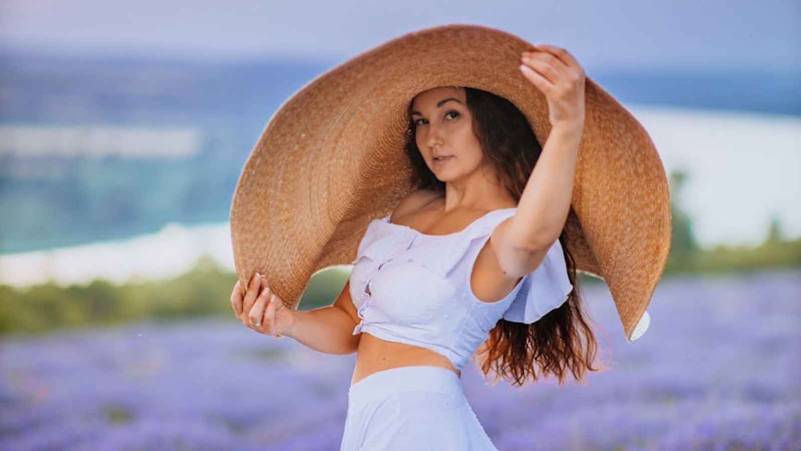 woman posing in lavender field at sunset